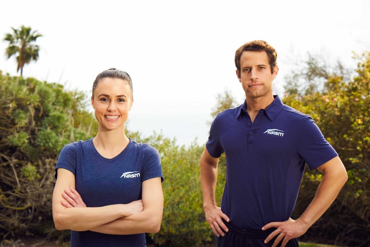 Two NASM trainers posing towards camera