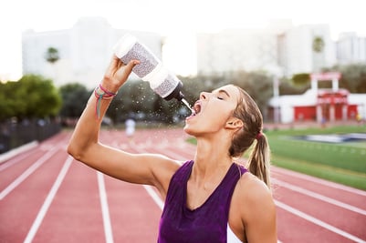 Woman drinking from water bottle