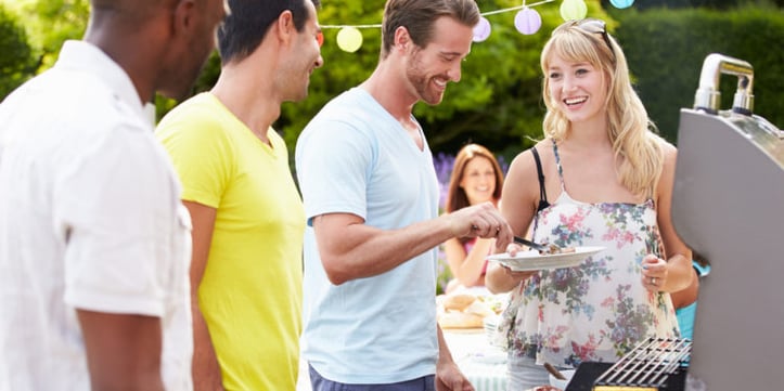 group of people enjoying food and talking outside