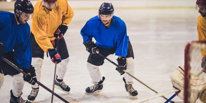 Male hockey players on ice rink