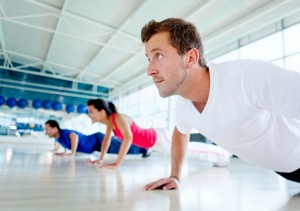 people doing push ups inside gym