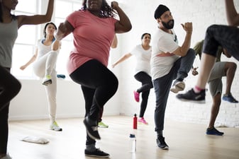 Adults Exercising in Group Fitness Class
