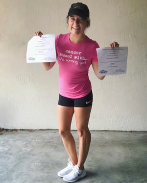 Ashley Williams holding up NASM certificates