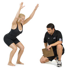 client doing an overhead squat assessment to correct hip flexors