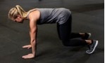 woman doing a bear crawl movement