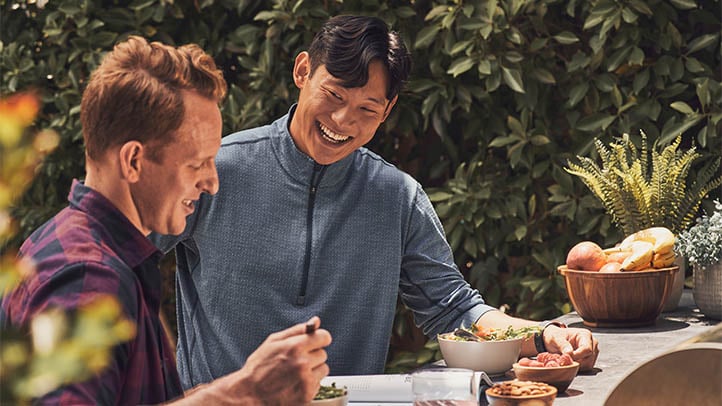 Two men eating outside