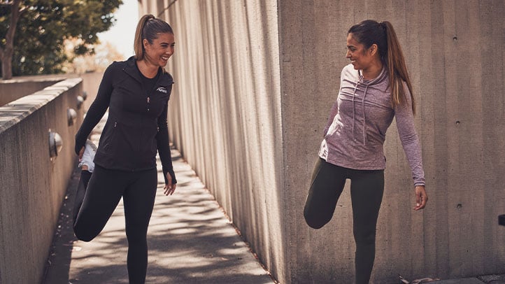 Woman NASM trainer with client stretching