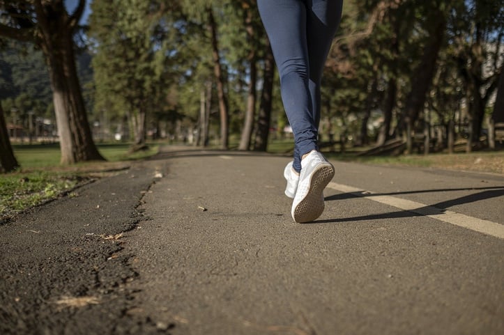 Person running on a paved trail outside