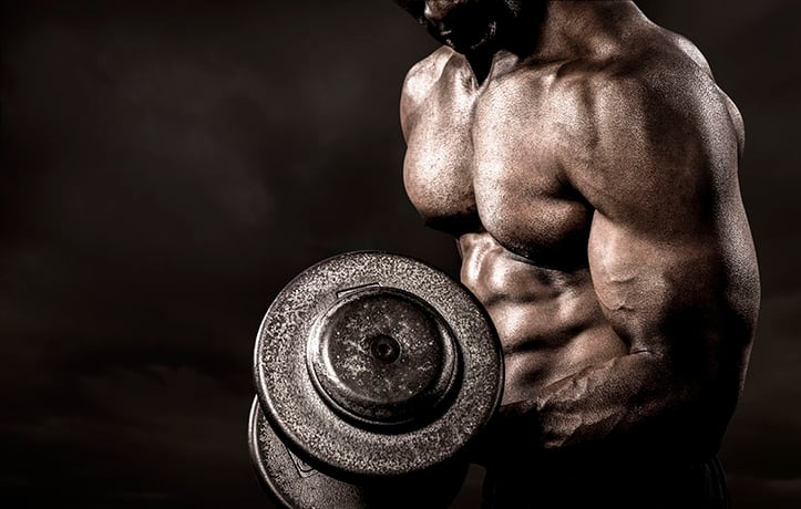 a bodybuilder doing a bicep curl with heavy dumbbell