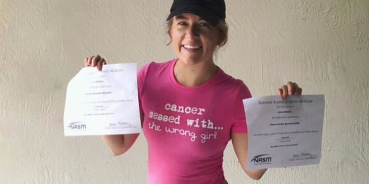 ashley williams holding up her nasm certification