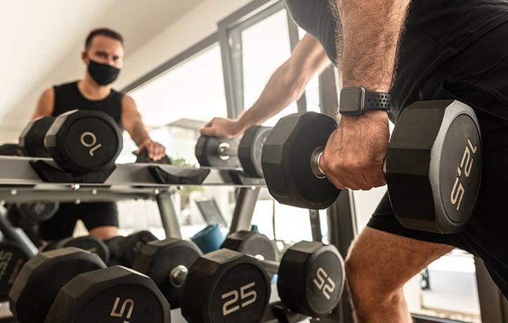 a man doing a drop set in the gym