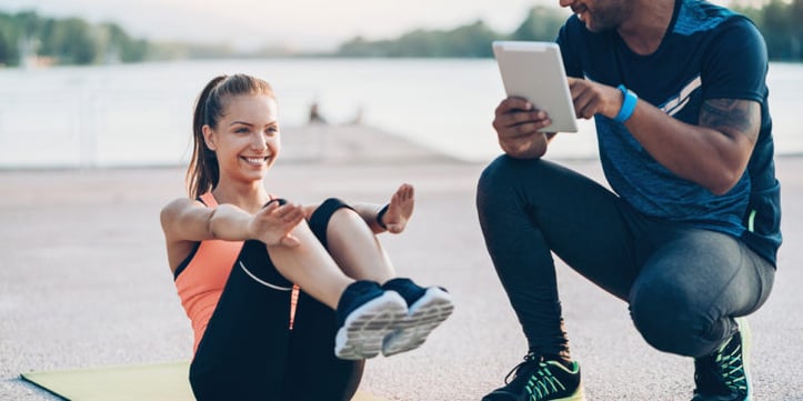 female trainer doing sit ups