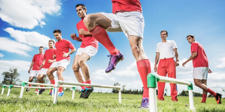 soccer players doing a drill outside