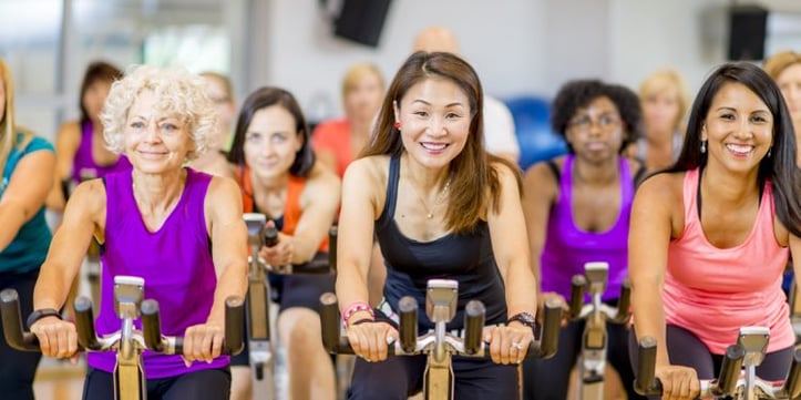 Group fitness class taking cycling class