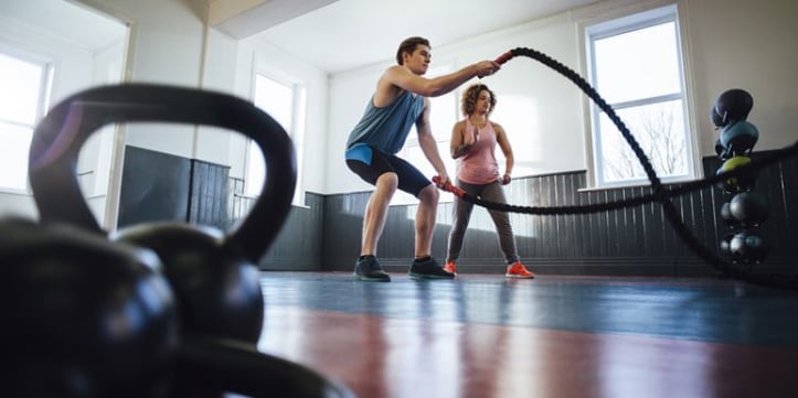 A man using ropes in a gym