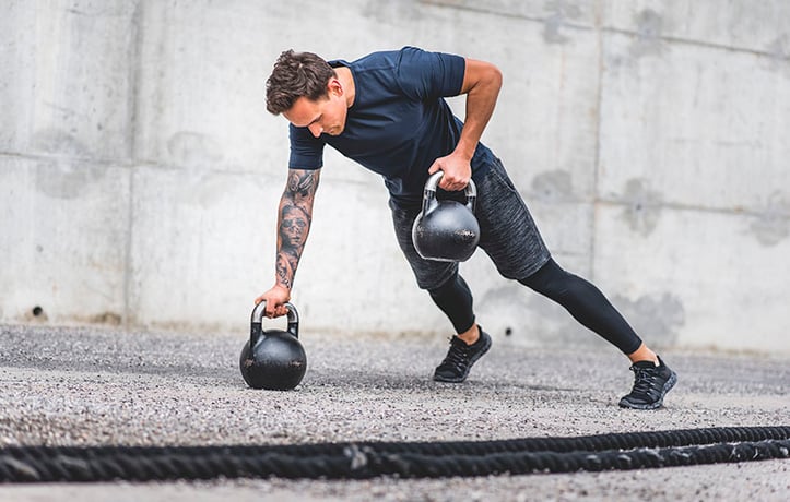 a man doing a kettlebell workout outside