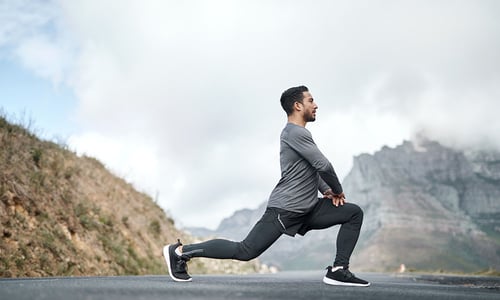 a man doing a lunge outdoors