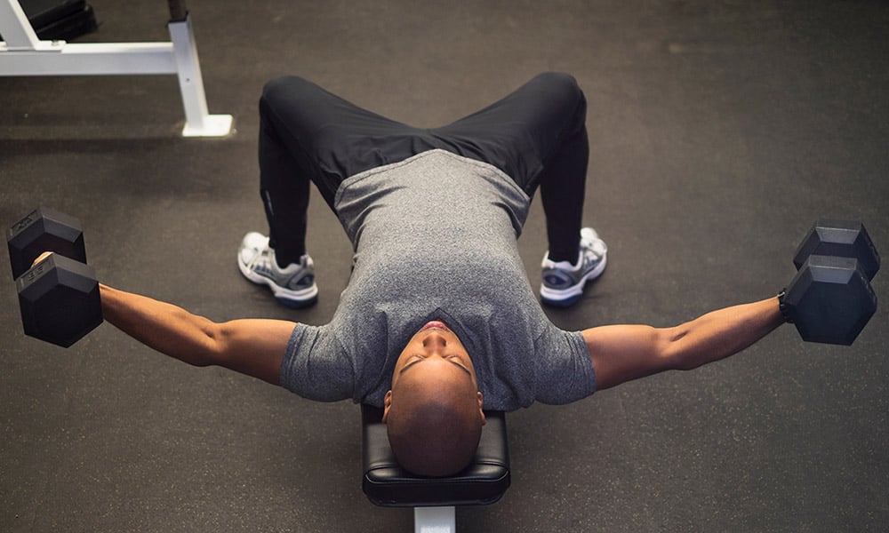 man on bench doing chest flys