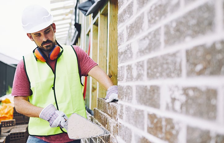 Constructor worker working on brick wall