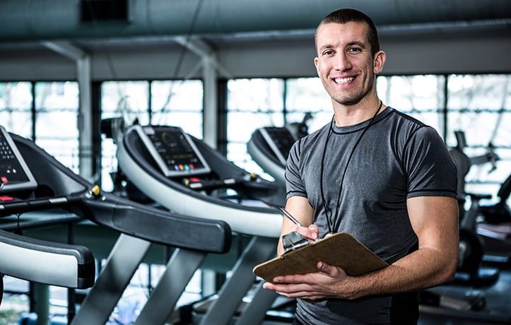 personal trainer holding a clipboard