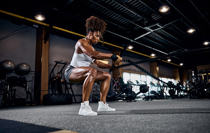 a woman doing battle ropes training