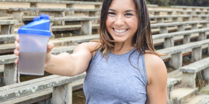 Trainer holding a protein shaker