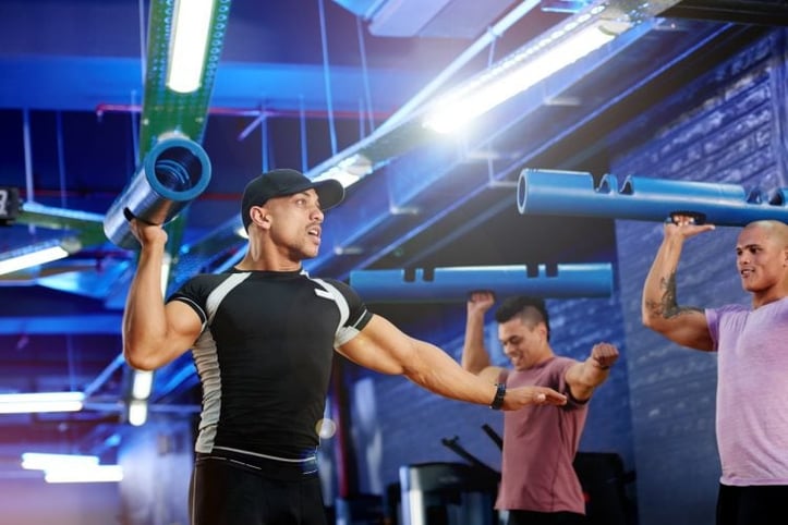 trainer assisting group fitness class