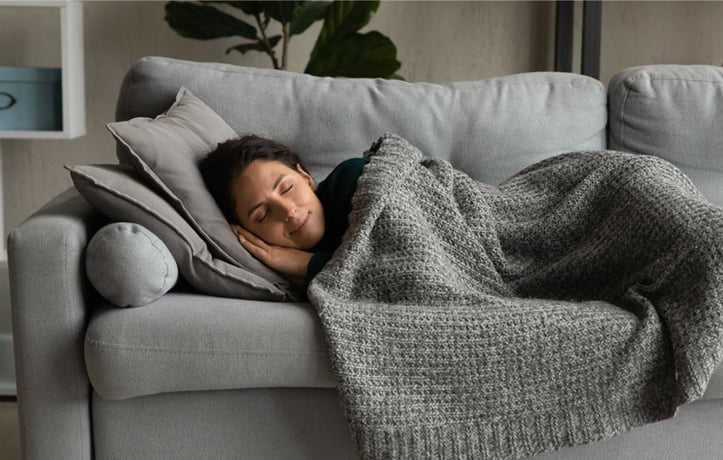 A lady taking a nap on a couch