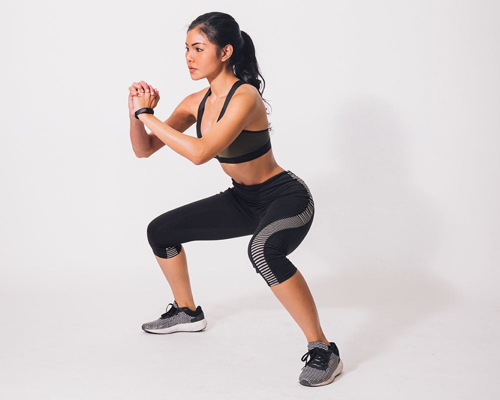 woman doing a squat hold