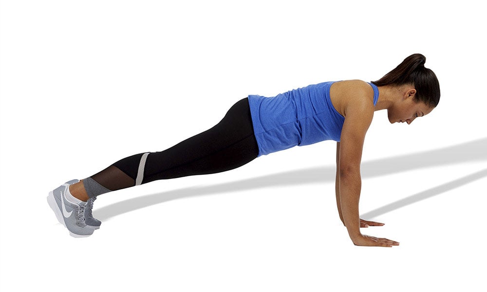 a woman performing a standard plank