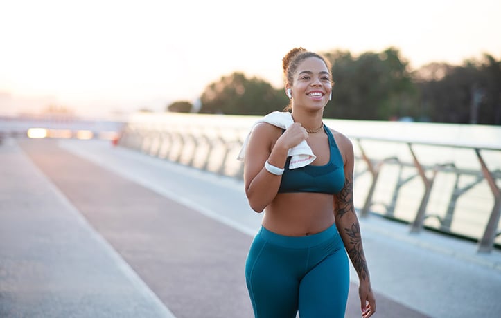 female walking outside with shirt over shoulder