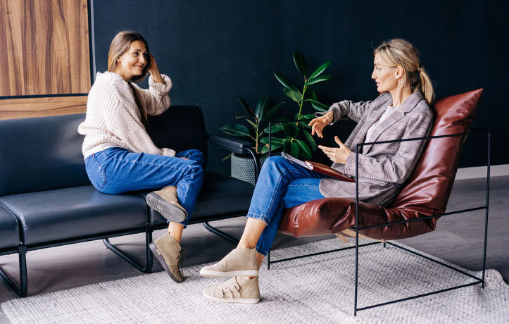 A woman smiling talking to a wellness coach