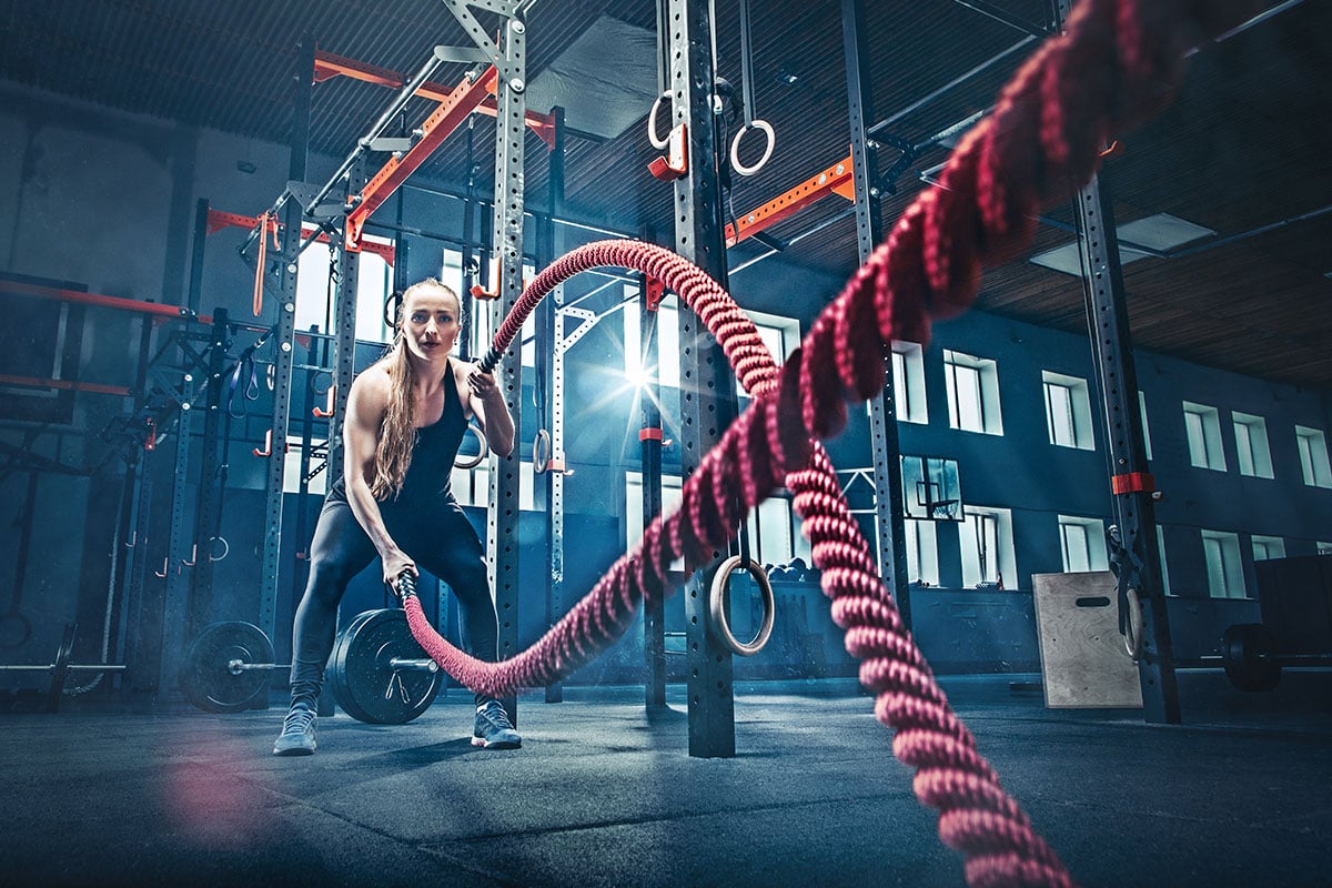 a woman doing a battle rope workout