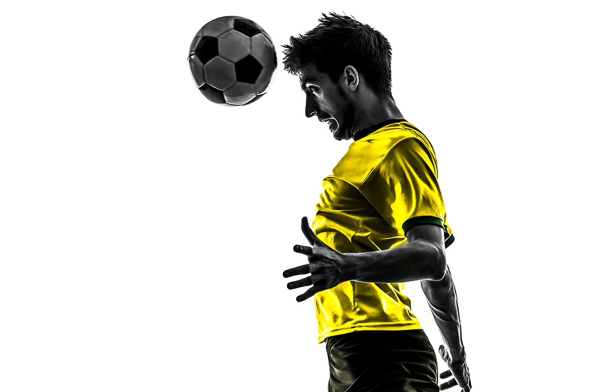 Soccer player hitting soccer ball with head