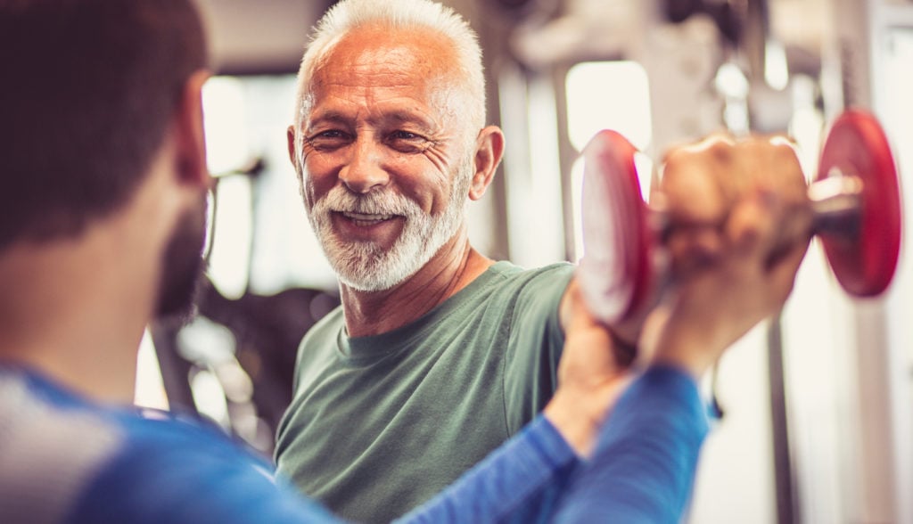 man lifting dumbbell