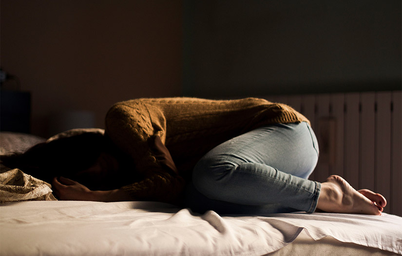 Stressed Woman on a Bed