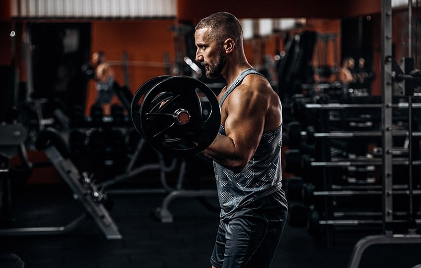 a man doing bicep curls during a bro split workout