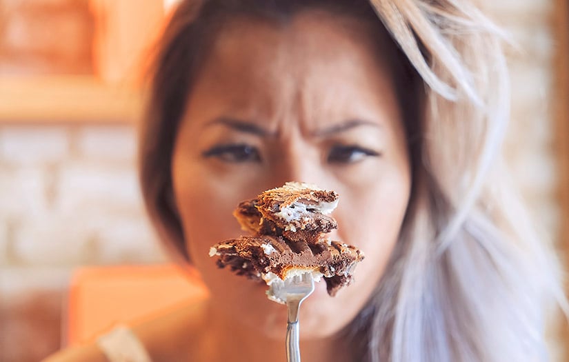 a woman eating a cheat meal