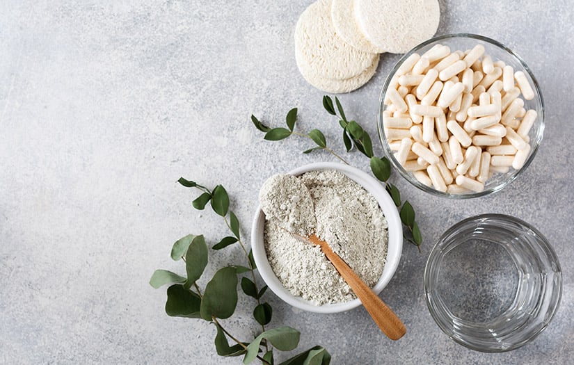 collagen supplements next to a bowl of collagen powder