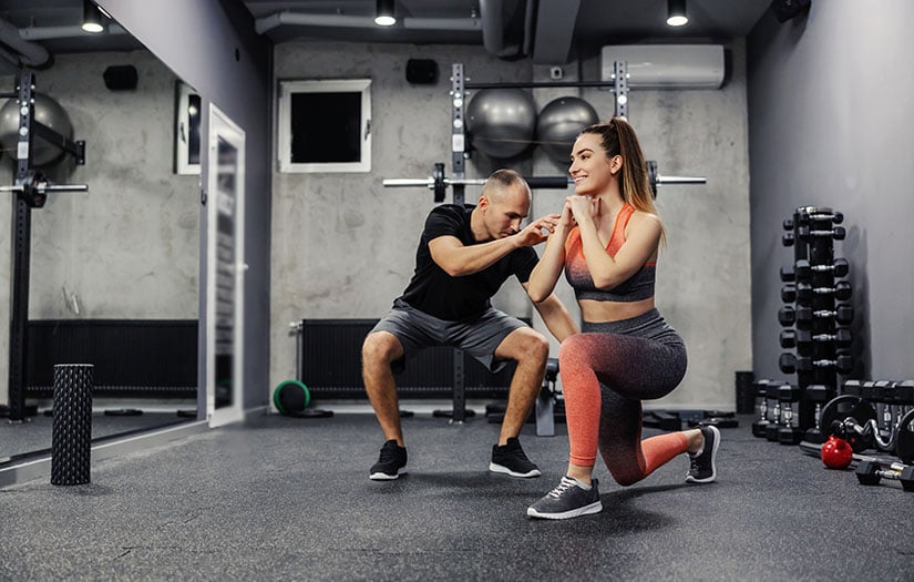 personal trainer working out with client