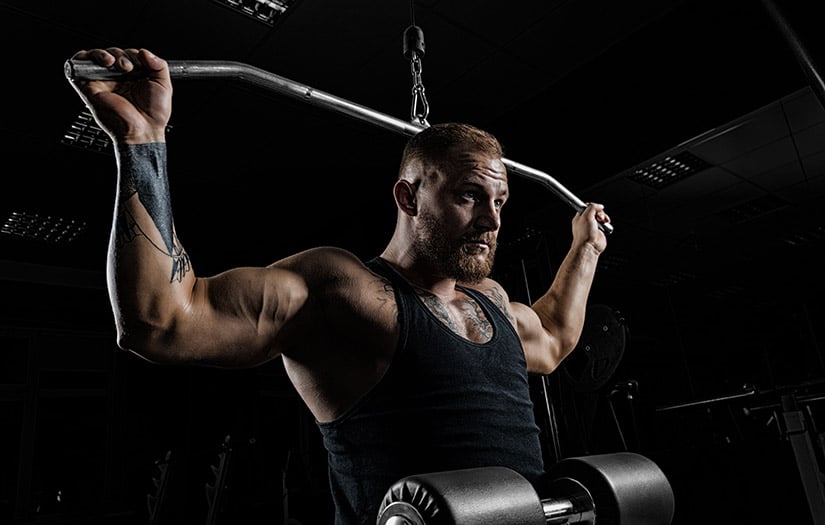 Man doing a hypertrophy workout with a lat pulldown