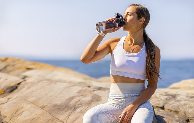 a woman hydrating after a workout