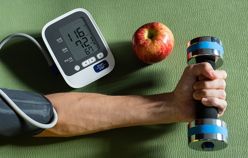 a person doing a bicep curl while taking their blood pressure