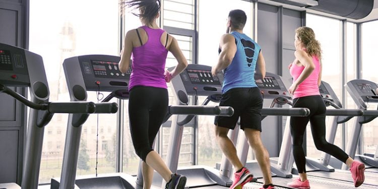 three people running on treadmills
