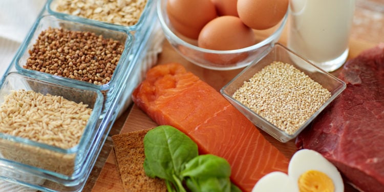 Salmon, eggs, and grains on table