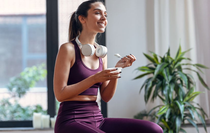 A woman eating yogurt