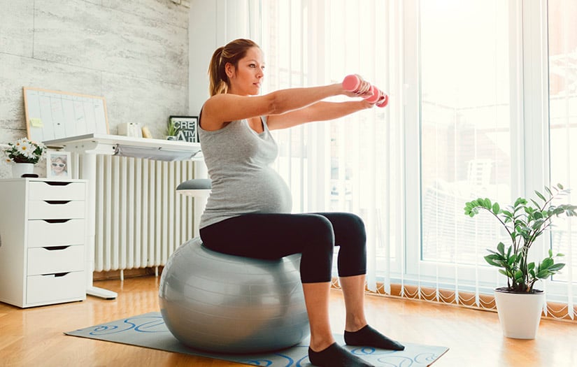 pregnant woman doing exercise on stability ball
