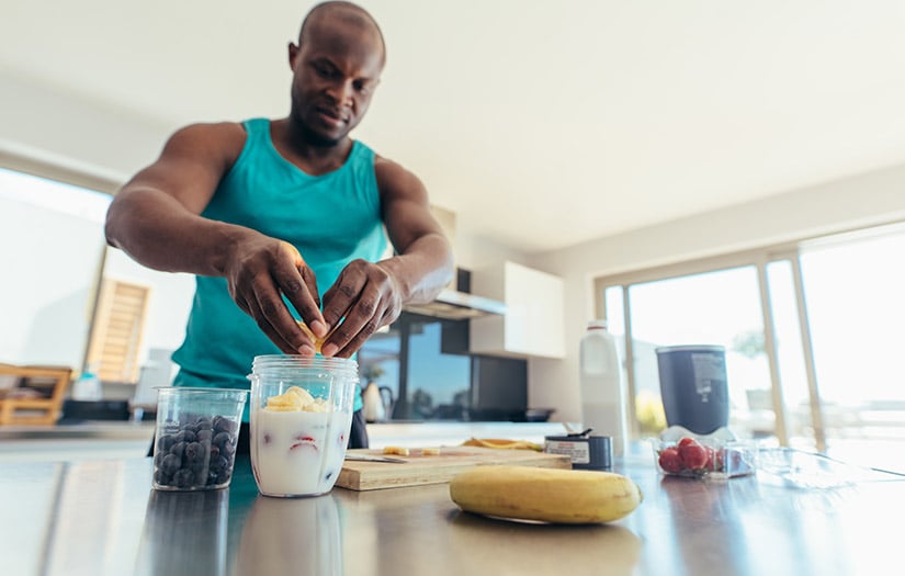 man making a smoothie before a workout