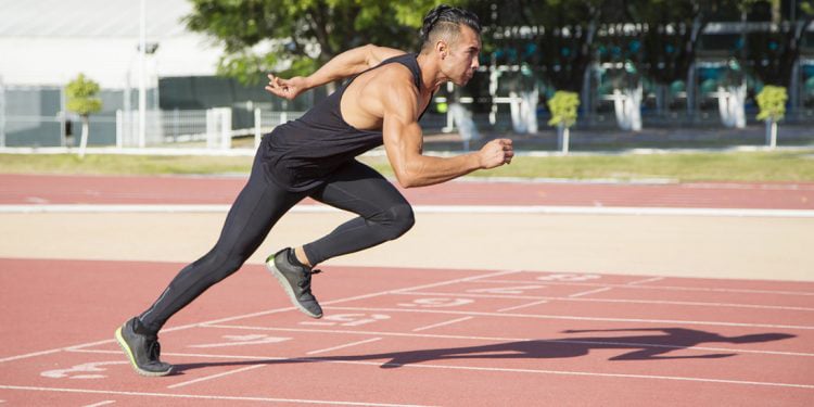 man doing sports performance training on a running track